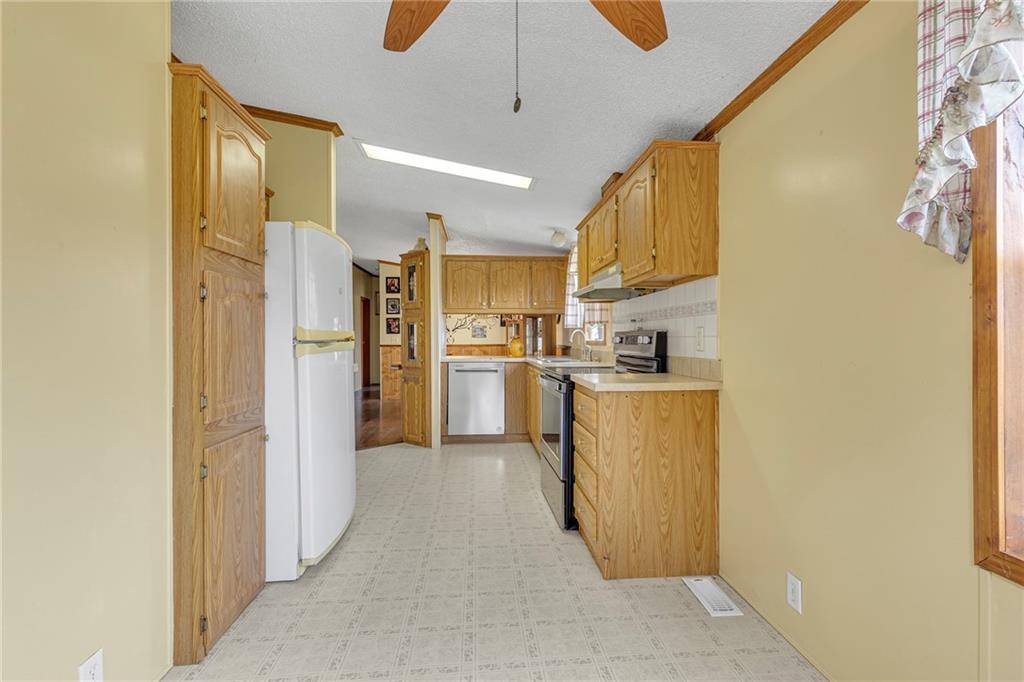 204 Hollowvue Road Wampum, PA 16157 - Photo 9 of 39 a view of kitchen with stainless steel appliances granite countertop cabinets and a counter top space
