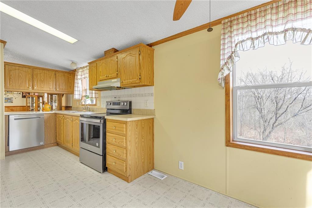 204 Hollowvue Road Wampum, PA 16157 - Photo 10 of 39 a kitchen with white cabinets and white appliances