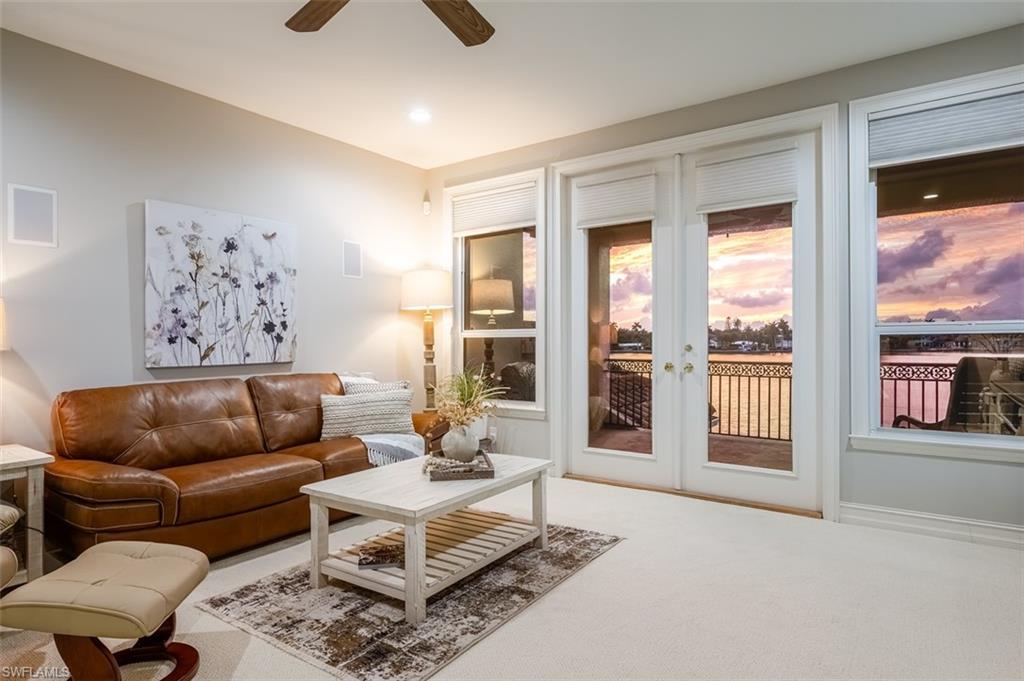 1942 Kingfish Road Naples, FL 34102 - Photo 33 of 43 a living room with furniture and a large window