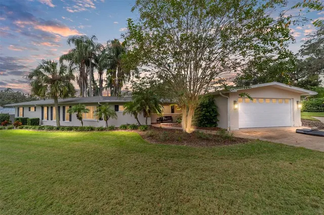 a living room with furniture a fireplace and a large window