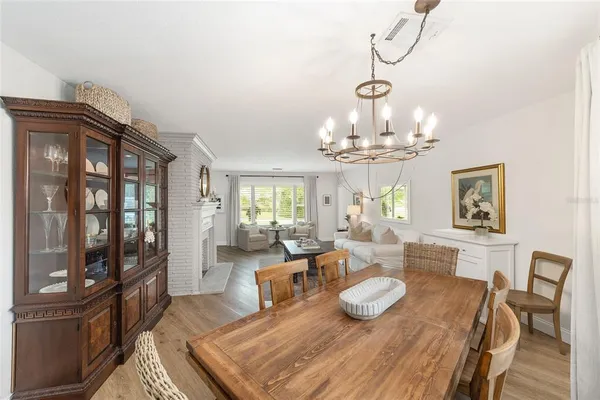 a living room with furniture dining table and wooden floor