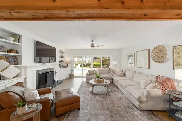 a view of a house with a yard and large trees