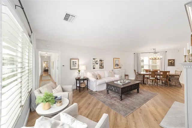 a kitchen with a dining table chairs stainless steel appliances and cabinets