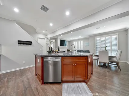 a kitchen with stainless steel appliances granite countertop a stove refrigerator and dining table