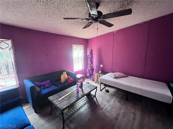 a room with furniture and a chandelier fan