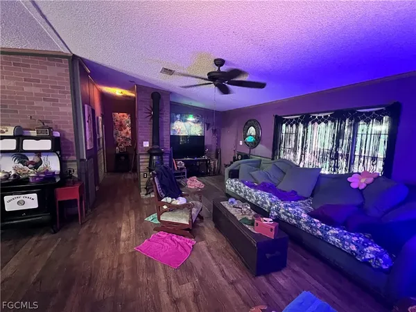a living room with furniture fireplace and wooden floor
