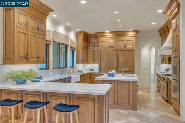a kitchen that has a table and chairs in it
