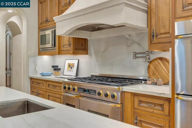 a kitchen with stainless steel appliances granite countertop a stove and a sink