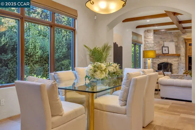 a dining room with furniture and a floor to ceiling window