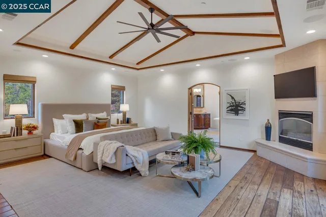 a bed room with a bed and a television