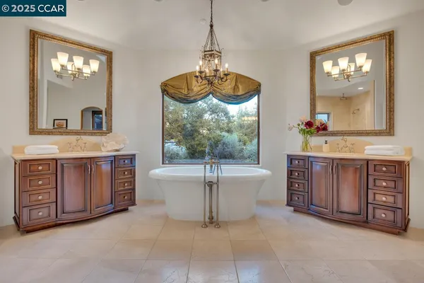 a bathroom with a double vanity sink toilet and shower