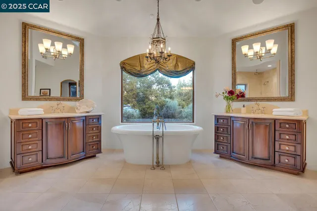 a bathroom with a double vanity sink toilet and shower