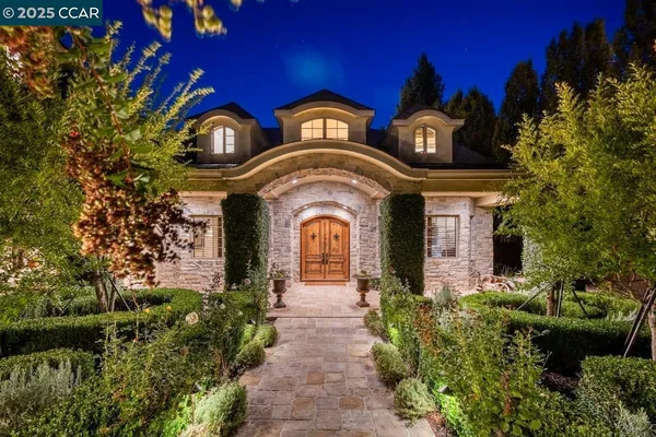 a front view of a house with a garden