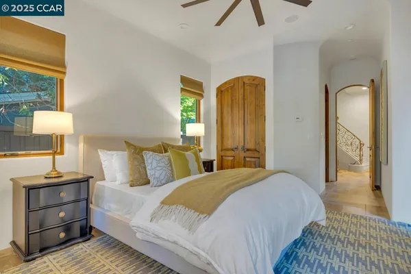 a bedroom with a bed a dresser next to a window