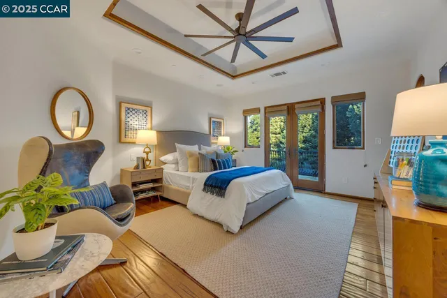 a bedroom with furniture and a large window