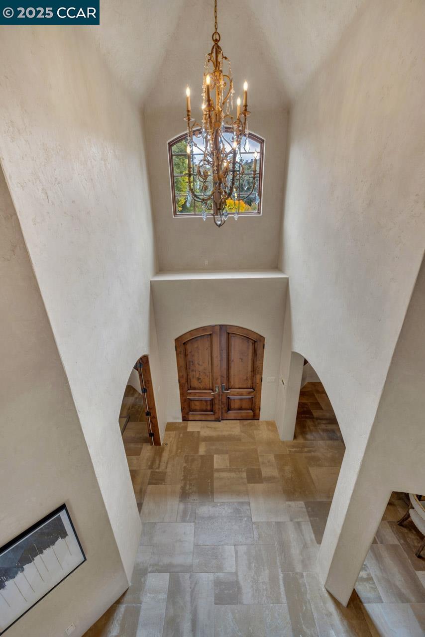 104 Muir Lane Alamo, CA 94507 - Photo 7 of 54 a living room with a fireplace furniture and a chandelier