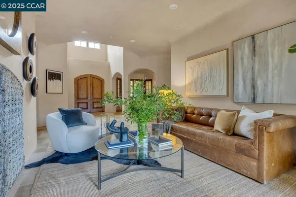 a living room with furniture and a potted plant