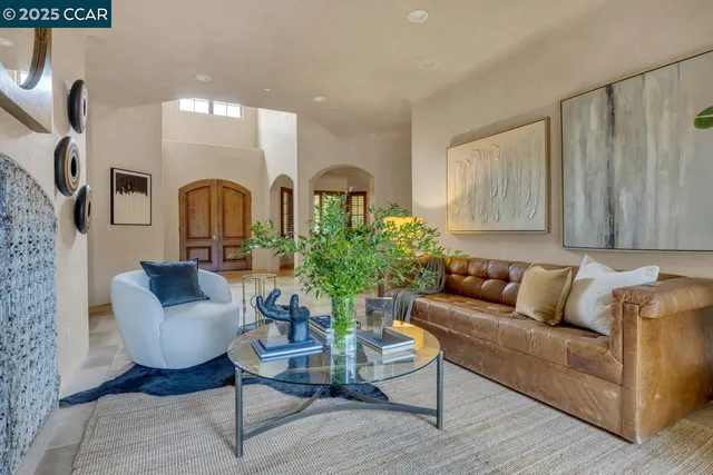 a living room with furniture and a potted plant