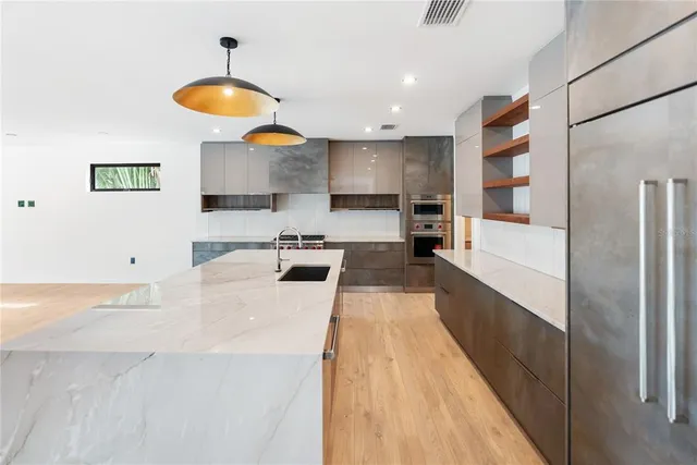 a view of a kitchen with a sink and a stove