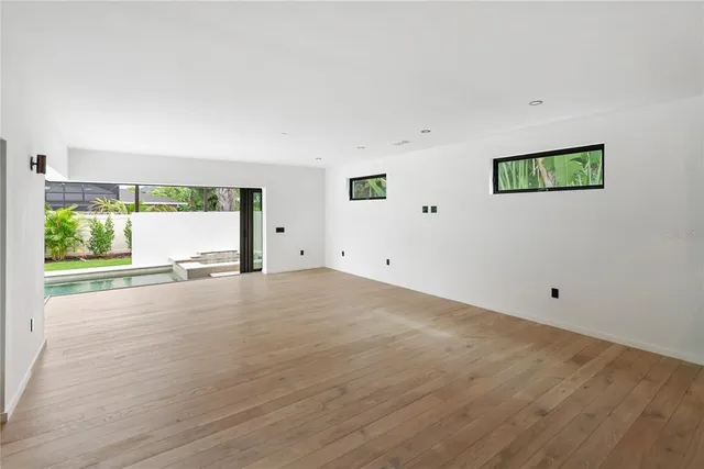 a view of a patio with table and chairs potted plants with palm trees
