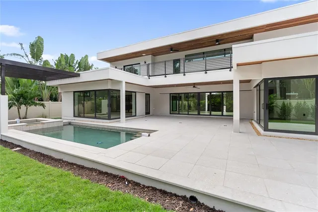 a bathroom with a double vanity sink a toilet and bathtub