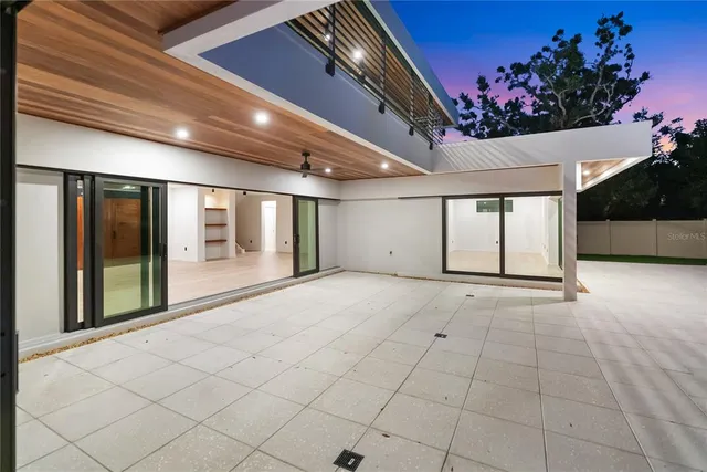 a view of empty room with window and wooden floor