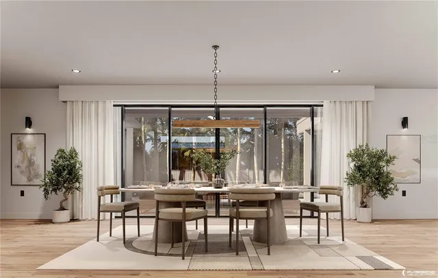 a large kitchen with stainless steel appliances a large counter top a stove a refrigerator and a sink