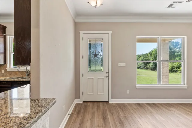 an open kitchen with kitchen island and stainless steel appliances