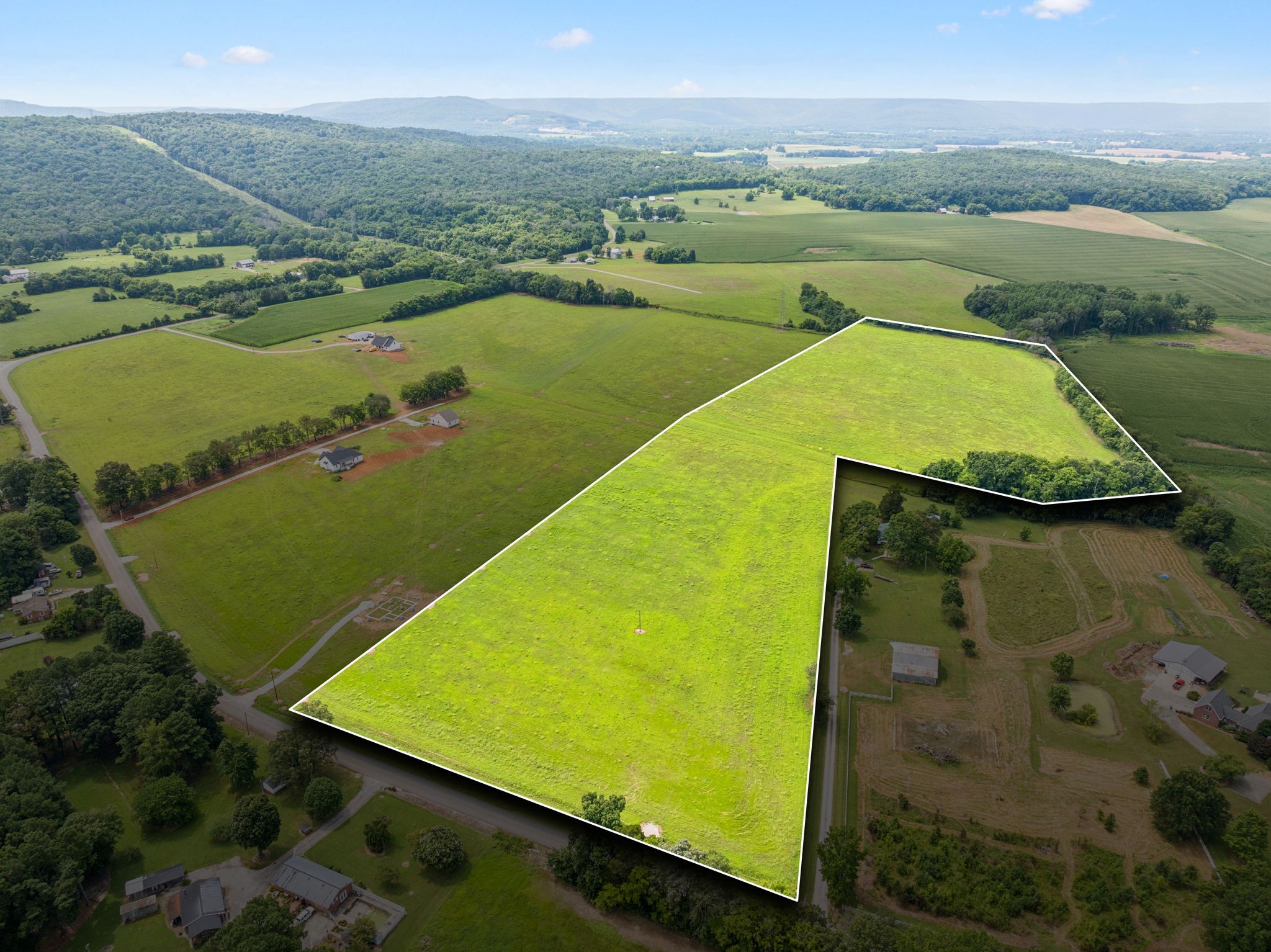 an aerial view of a residential houses with outdoor space