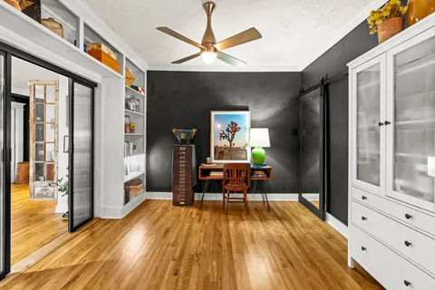 a living room with furniture and a wooden floor
