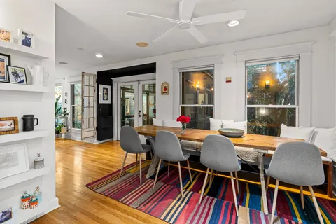 a view of a dining room with furniture and wooden floor