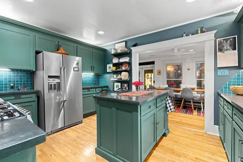 a kitchen with stainless steel appliances granite countertop a refrigerator and a stove
