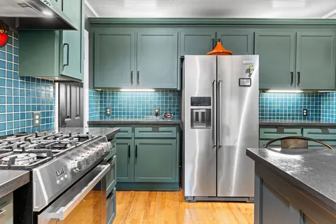 a kitchen with a refrigerator and a sink