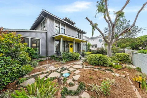 a front view of a house with garden