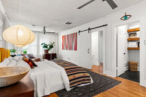 a bedroom with bed and a mirror