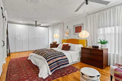 a bedroom with a bed dresser and a window