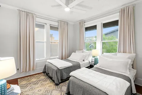 a bedroom with two beds and a window