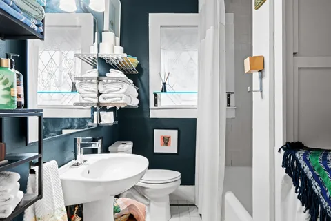 a bathroom with a toilet a sink and a mirror