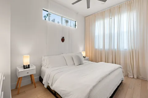 a bedroom with a bed and a window