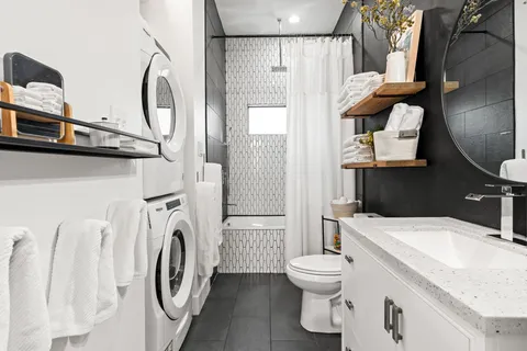 a bathroom with a sink a toilet and shower