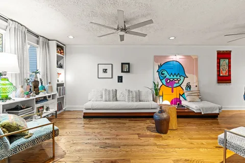 a living room with furniture and wooden floor