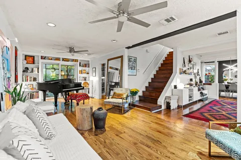 a living room with furniture and wooden floor