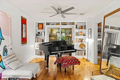 a living room with furniture a rug and a chandelier