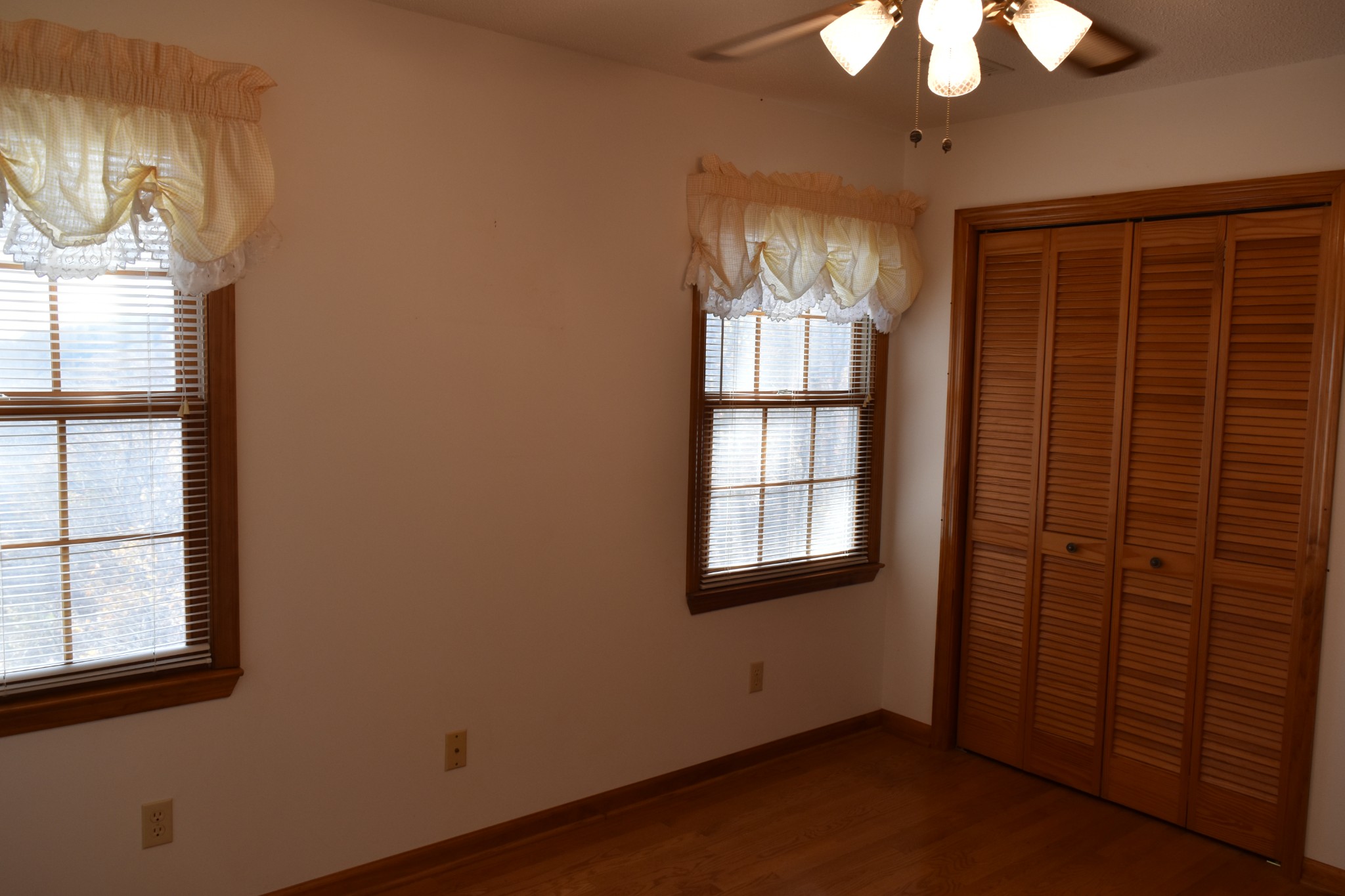 1454 Stagecoach Road Sewanee, TN 37375 - Photo 46 of 75 an empty room with windows and chandelier fan