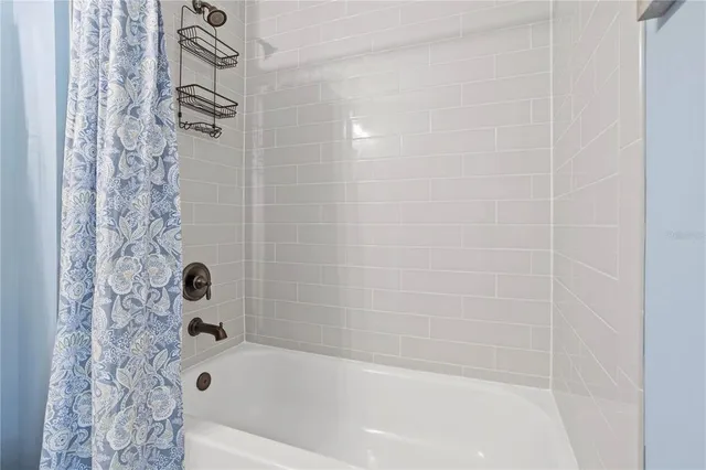 a view of a house with a small yard plants and large tree