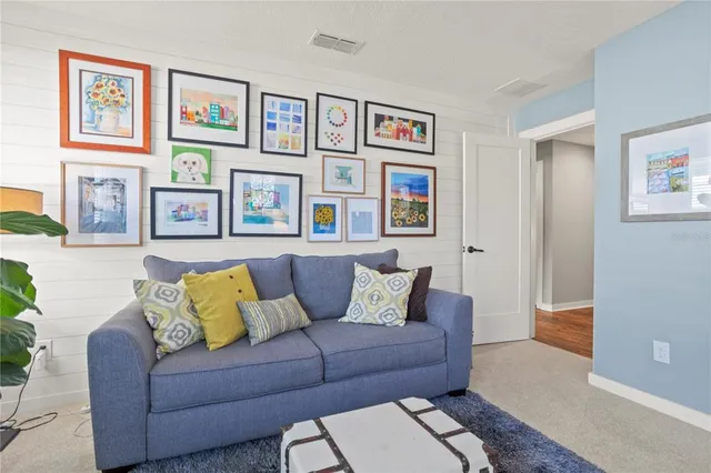 an aerial view of ocean and residential houses with outdoor space