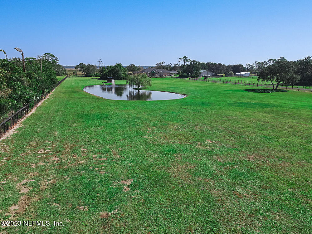 12625 Sawpit Road Jacksonville, FL 32226 - Photo 21 of 63 a view of a green field with mountains in the background
