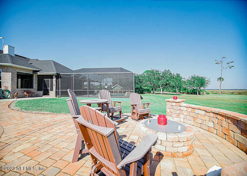 12625 Sawpit Road Jacksonville, FL 32226 - Photo 23 of 63 a view of a patio with a table and chairs