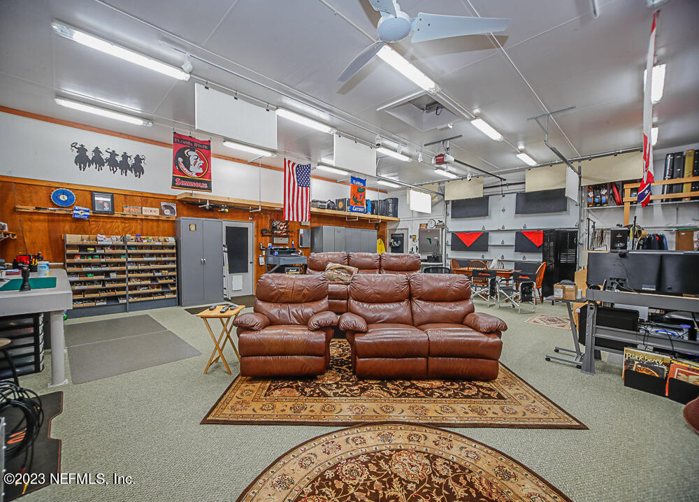 12625 Sawpit Road Jacksonville, FL 32226 - Photo 32 of 63 a living room with furniture a flat screen tv and a fireplace
