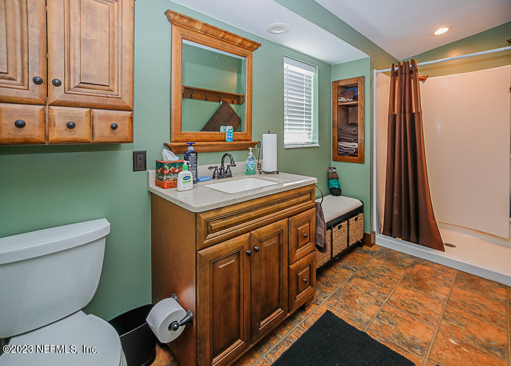 12625 Sawpit Road Jacksonville, FL 32226 - Photo 33 of 63 a bathroom with a toilet sink and mirror
